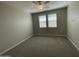 Bedroom with neutral walls, plush carpeting, and natural light from two large windows at 24146 N 162Nd Ln, Surprise, AZ 85387
