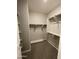 Walk-in closet with neutral walls, shelving, rod for hangers, and plush carpeted floors at 24146 N 162Nd Ln, Surprise, AZ 85387