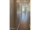 Bright hallway featuring wood-look flooring, leading to an open space and other rooms, offering a seamless transition at 24146 N 162Nd Ln, Surprise, AZ 85387