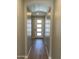 Hallway featuring a white four-panel door and natural light at 24146 N 162Nd Ln, Surprise, AZ 85387