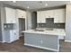 Modern kitchen with white cabinetry, a center island, and sleek countertops, creating a bright and functional cooking space at 24146 N 162Nd Ln, Surprise, AZ 85387
