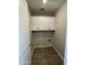 Practical laundry room with white cabinets, wood-look flooring, and visible utility connections for convenience at 24146 N 162Nd Ln, Surprise, AZ 85387