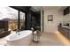 Modern bathroom showcasing a freestanding tub, glass-enclosed shower, and desert landscape views at 24651 N 127Th Way # 30, Scottsdale, AZ 85255