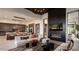 Open concept living room with modern fireplace, stylish furnishings and seamless flow into the kitchen area at 24651 N 127Th Way # 30, Scottsdale, AZ 85255