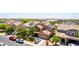 Suburban home with lush landscaping, mature trees, and solar panels visible from an aerial view at 283 W Tahiti Dr, Casa Grande, AZ 85122
