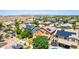 An aerial view showcasing homes with pools and solar panels in a sunny community at 283 W Tahiti Dr, Casa Grande, AZ 85122