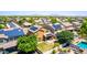 Aerial view showcasing a home with a well-maintained yard, patio, and solar panels in a vibrant community at 283 W Tahiti Dr, Casa Grande, AZ 85122
