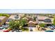 Aerial view of a suburban home featuring mature trees, lush landscaping, and solar panels on the roof at 283 W Tahiti Dr, Casa Grande, AZ 85122