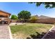 Extensive backyard includes a built-in grill, fire pit, and a well-manicured lawn, perfect for relaxing at 283 W Tahiti Dr, Casa Grande, AZ 85122
