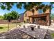 Inviting backyard featuring a cozy fire pit, built-in grill, and ample seating for outdoor entertaining at 283 W Tahiti Dr, Casa Grande, AZ 85122
