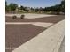 Outdoor basketball court with well-maintained landscaping and sidewalks around the court at 283 W Tahiti Dr, Casa Grande, AZ 85122