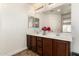 Bright bathroom featuring a double vanity, large mirror, and modern fixtures at 283 W Tahiti Dr, Casa Grande, AZ 85122