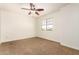 Bright bedroom featuring neutral carpeting, a ceiling fan and natural light at 283 W Tahiti Dr, Casa Grande, AZ 85122