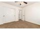Neutral bedroom with a ceiling fan, plush carpet, and a closet, creating a cozy retreat at 283 W Tahiti Dr, Casa Grande, AZ 85122