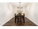 Formal dining area featuring a wooden table set for six, with modern light fixture and wood flooring at 283 W Tahiti Dr, Casa Grande, AZ 85122