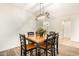 Dining room featuring a wood table set for six, complimented by stylish wood flooring and neutral walls at 283 W Tahiti Dr, Casa Grande, AZ 85122