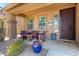 Inviting front porch with comfortable seating, potted plants, and a welcoming atmosphere at 283 W Tahiti Dr, Casa Grande, AZ 85122