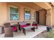 Cozy front porch offers a relaxing space with comfortable seating and decorative plants at 283 W Tahiti Dr, Casa Grande, AZ 85122