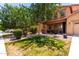 Lovely home featuring a lush lawn, mature tree, and a cozy front porch at 283 W Tahiti Dr, Casa Grande, AZ 85122
