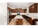 Spacious kitchen features stainless steel appliances, a kitchen island, and dark wood cabinets, offering style and functionality at 283 W Tahiti Dr, Casa Grande, AZ 85122
