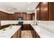 Spacious kitchen boasts rich wood cabinetry, sleek countertops, and modern appliances at 283 W Tahiti Dr, Casa Grande, AZ 85122