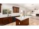 Modern kitchen with stainless steel appliances, an island with a white countertop, and ample natural light at 283 W Tahiti Dr, Casa Grande, AZ 85122
