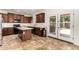 Bright, airy kitchen with stainless steel appliances, a kitchen island, and dark wood cabinets, offering modern style and function at 283 W Tahiti Dr, Casa Grande, AZ 85122