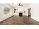 Open living room featuring a fireplace, built-in shelving, and bright windows, highlighted by sleek, wood-look floors at 283 W Tahiti Dr, Casa Grande, AZ 85122