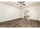 Open-concept living room features wood-look tile flooring and ceiling fan at 283 W Tahiti Dr, Casa Grande, AZ 85122