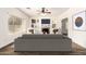 Bright living room featuring a cozy fireplace, a ceiling fan, and stylish built-in shelving at 283 W Tahiti Dr, Casa Grande, AZ 85122