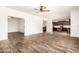 Spacious open-concept featuring wood-look floors, seamlessly connects the living area to the dining and kitchen spaces at 283 W Tahiti Dr, Casa Grande, AZ 85122