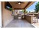 Covered patio with grill, bar, and ceiling fan, perfect for outdoor dining and entertainment at 283 W Tahiti Dr, Casa Grande, AZ 85122