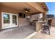 Enjoy outdoor living on this covered patio with a ceiling fan, built-in grill, and bar seating at 283 W Tahiti Dr, Casa Grande, AZ 85122