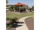 Community playground featuring slides, climbing structures, and shade in a Gathering-friendly neighborhood at 283 W Tahiti Dr, Casa Grande, AZ 85122