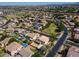 Expansive aerial view of a suburban neighborhood showcasing well-maintained homes, green spaces, and community amenities at 2880 E Nunneley Rd, Gilbert, AZ 85296