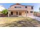 Backyard with grassy area, covered patio, and views of the home's exterior at 2880 E Nunneley Rd, Gilbert, AZ 85296