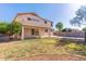 Large grassy backyard with covered patio, block fence, and view of the home's exterior at 2880 E Nunneley Rd, Gilbert, AZ 85296
