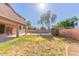 Spacious backyard featuring a grassy area with mature landscaping and block fence at 2880 E Nunneley Rd, Gilbert, AZ 85296