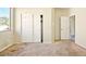 Bedroom features neutral carpet, a closet with sliding doors and a view out the window at 2880 E Nunneley Rd, Gilbert, AZ 85296