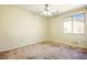 An open bedroom featuring neutral carpet and a bright window that overlooks the green outdoors at 2880 E Nunneley Rd, Gilbert, AZ 85296