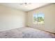 Bedroom with large window overlooking greenery offering natural light at 2880 E Nunneley Rd, Gilbert, AZ 85296