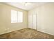 Cozy bedroom featuring neutral carpet, double door closet and a bright window overlooking the outdoors at 2880 E Nunneley Rd, Gilbert, AZ 85296