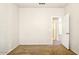 An open room with neutral carpet and a doorway leading to the bedroom's closet, enhancing accessibility at 2880 E Nunneley Rd, Gilbert, AZ 85296