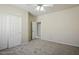 Carpeted bedroom features a built-in closet for optimal storage and organization at 2880 E Nunneley Rd, Gilbert, AZ 85296