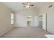 Spacious bedroom showcasing ceiling fan and access to closet and en suite at 2880 E Nunneley Rd, Gilbert, AZ 85296