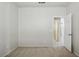 Cozy bedroom showcasing neutral walls, soft carpet, and an entry door at 2880 E Nunneley Rd, Gilbert, AZ 85296