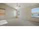Bright bedroom featuring a ceiling fan, plush carpet and windows for natural light at 2880 E Nunneley Rd, Gilbert, AZ 85296