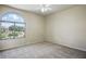 Spacious bedroom with a ceiling fan and large window offering bright, natural light at 2880 E Nunneley Rd, Gilbert, AZ 85296