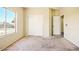Bedroom features carpet and window with a view of the neighborhood at 2880 E Nunneley Rd, Gilbert, AZ 85296
