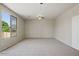 Large bedroom with carpet, ceiling fan, a big bright window, and a closet for ample storage at 2880 E Nunneley Rd, Gilbert, AZ 85296